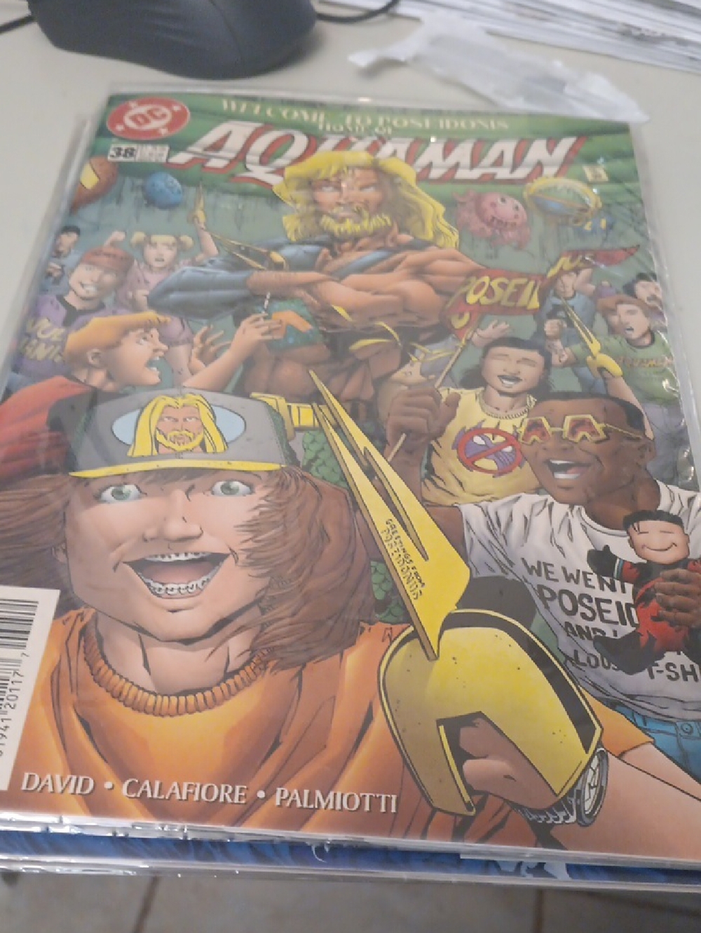 DC Aquaman Comic Cover – Green, Yellow, Blue Accents In A Sleeve
